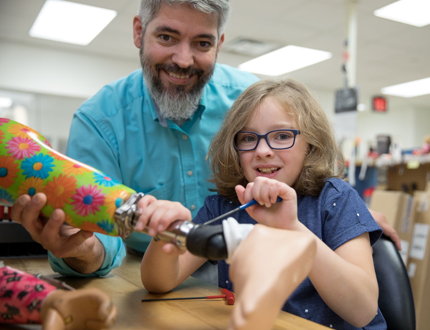 orthotist and patient work on prosthetic leg